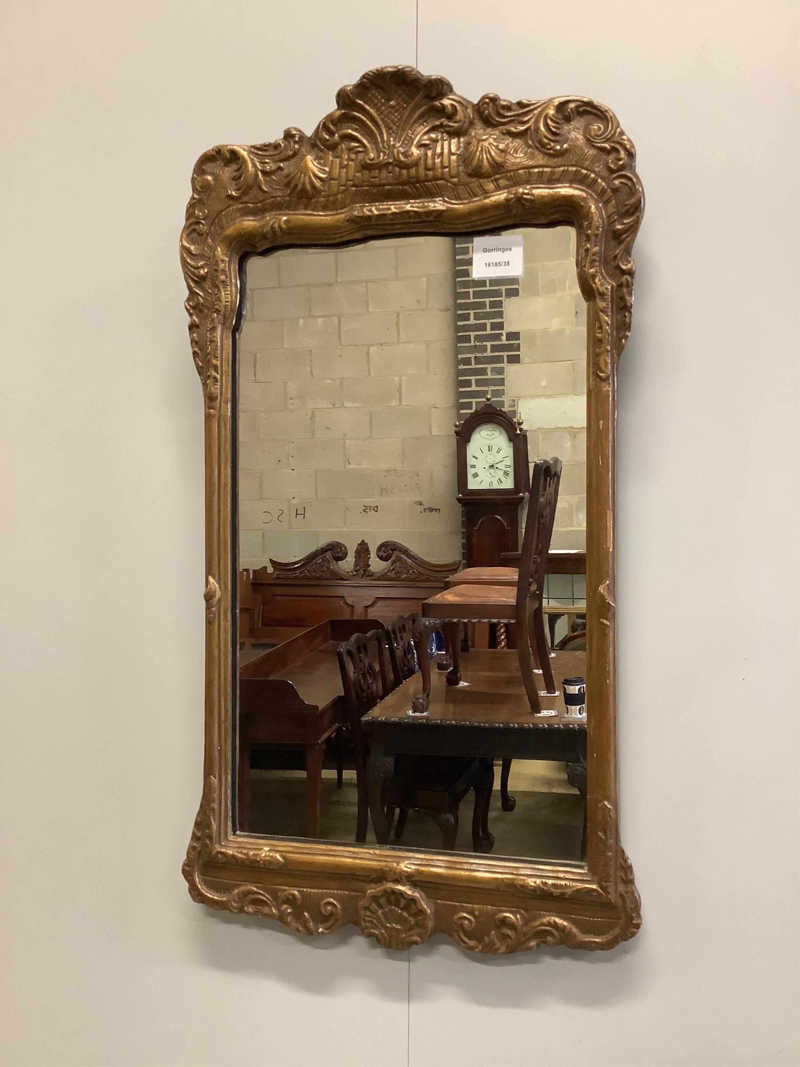 A George I style gilt wall mirror, width 39cm, height 70cm. Condition - fair